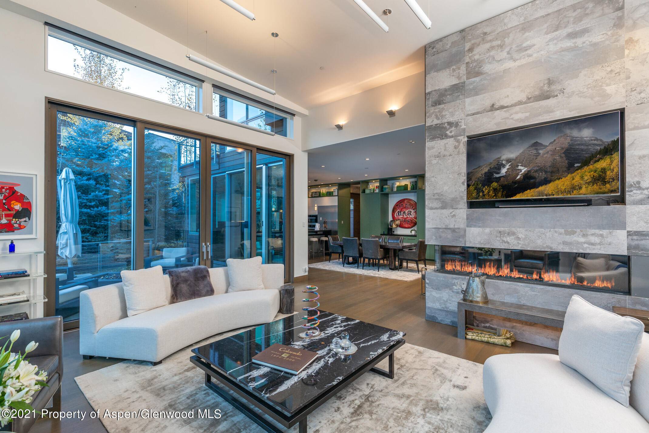 This magnificent home has an exclusively serene setting overlooking the Roaring Fork River and protected open space.