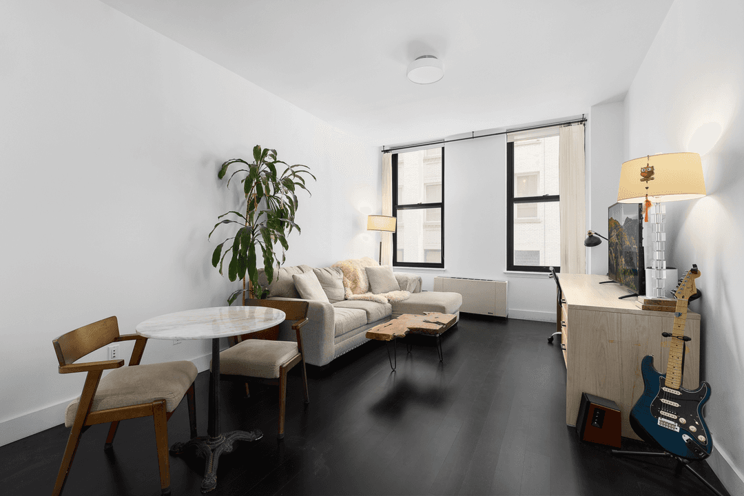 Residence 7M at The Broad Exchange Building is a spacious 747 square foot one bedroom home with an in unit washer dryer, blending timeless elegance with modern comfort.