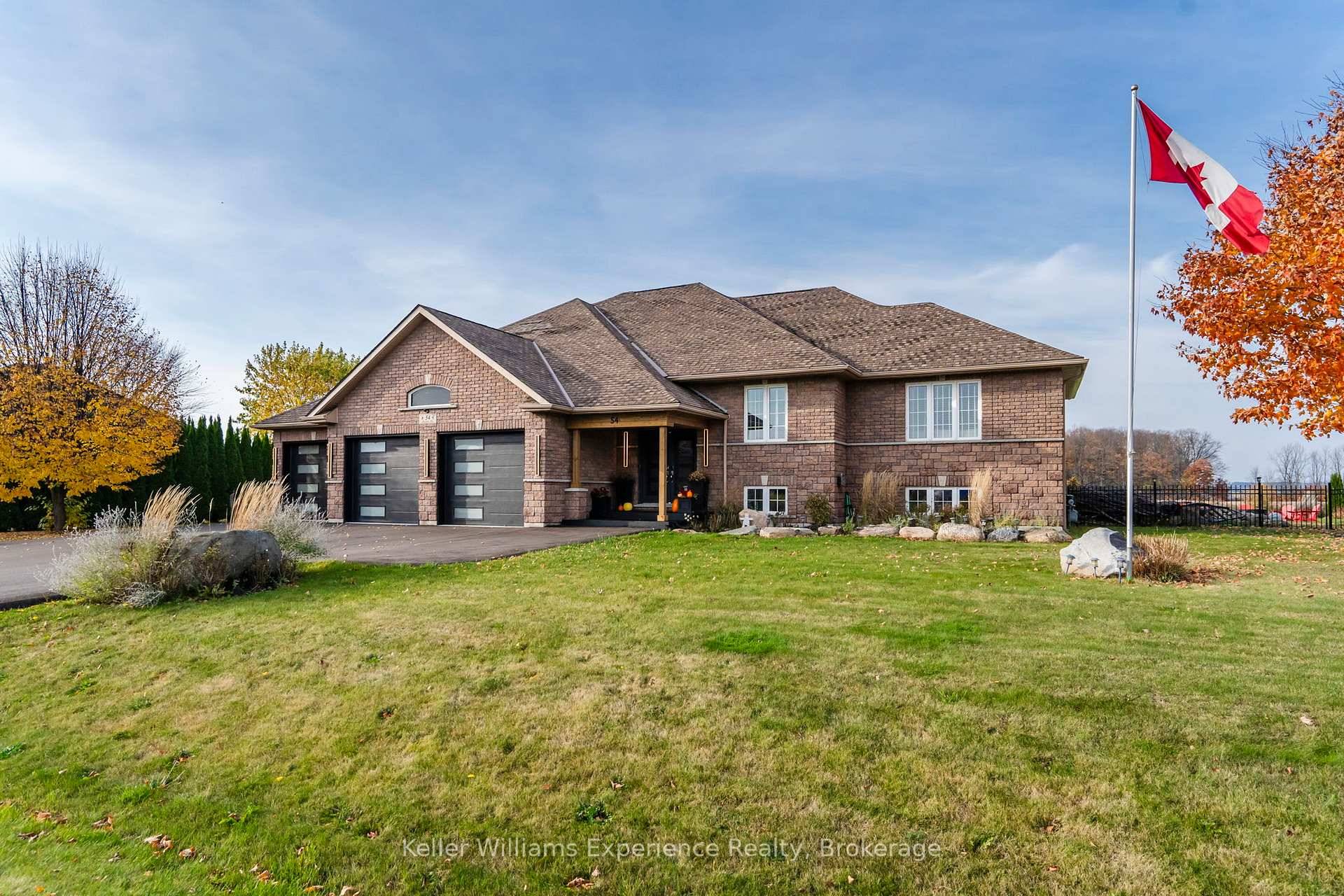 Nestled on a beautifully landscaped, 1 acre lot is this custom built brick bungalow, surrounded by scenic farm fields in a quiet location.