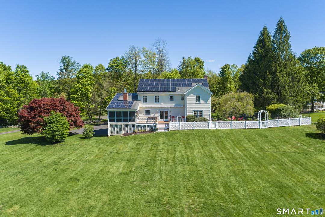 Classic Center Hall Colonial beautifully sited in highly desirable Ridgebury.