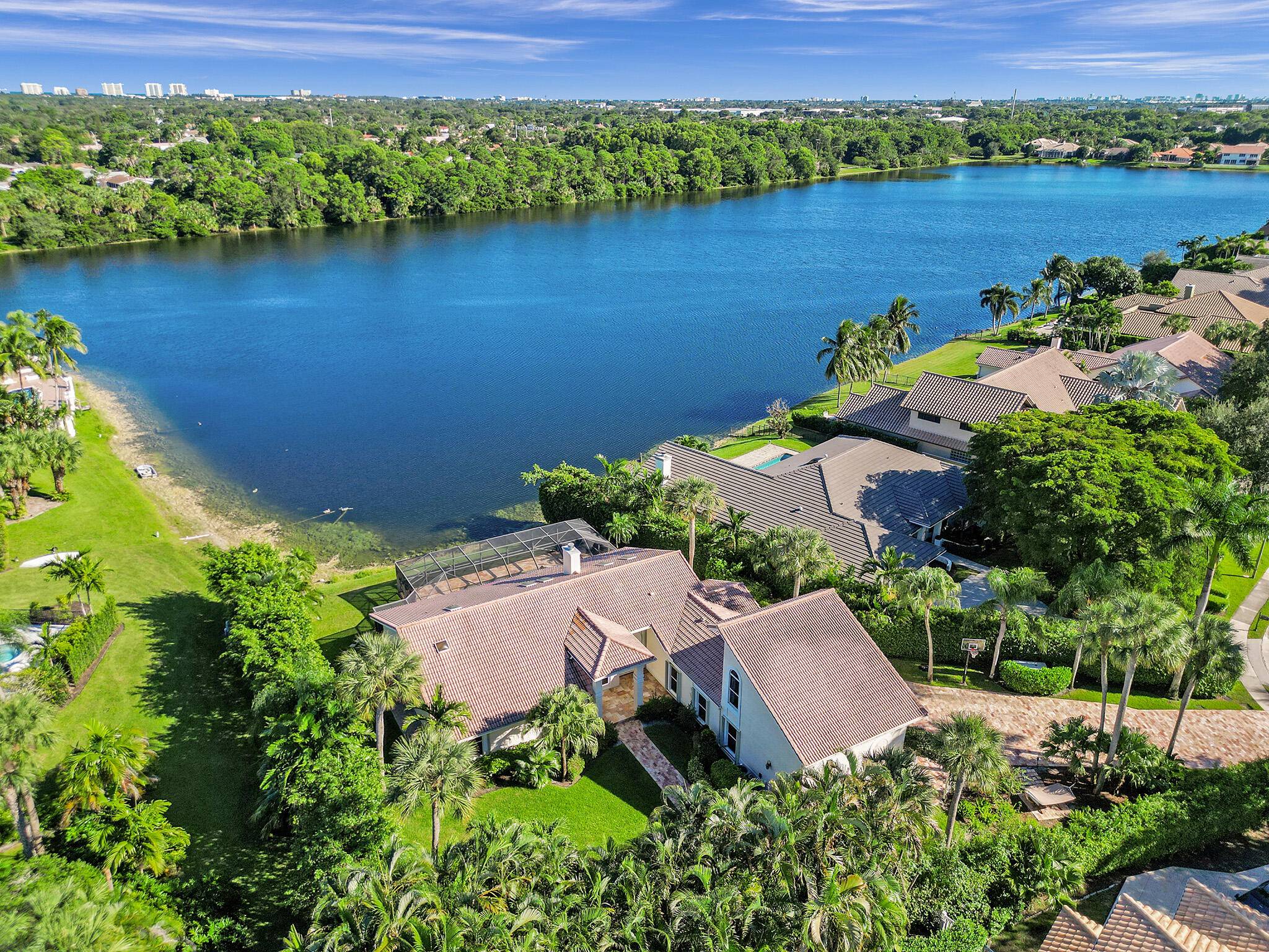 A unique opportunity to own this gorgeous private estate located on a waterfront lot in the charming gated community of Boca Raton Sailing Racquet Club.