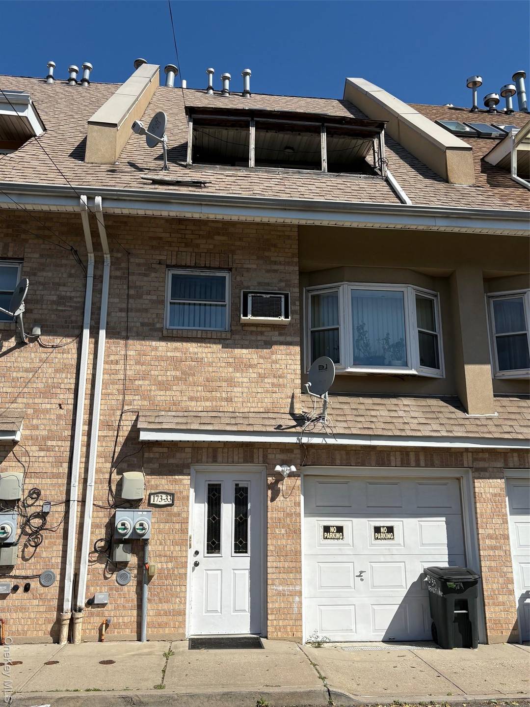 2 family attached brick with a 1 car built in garage.