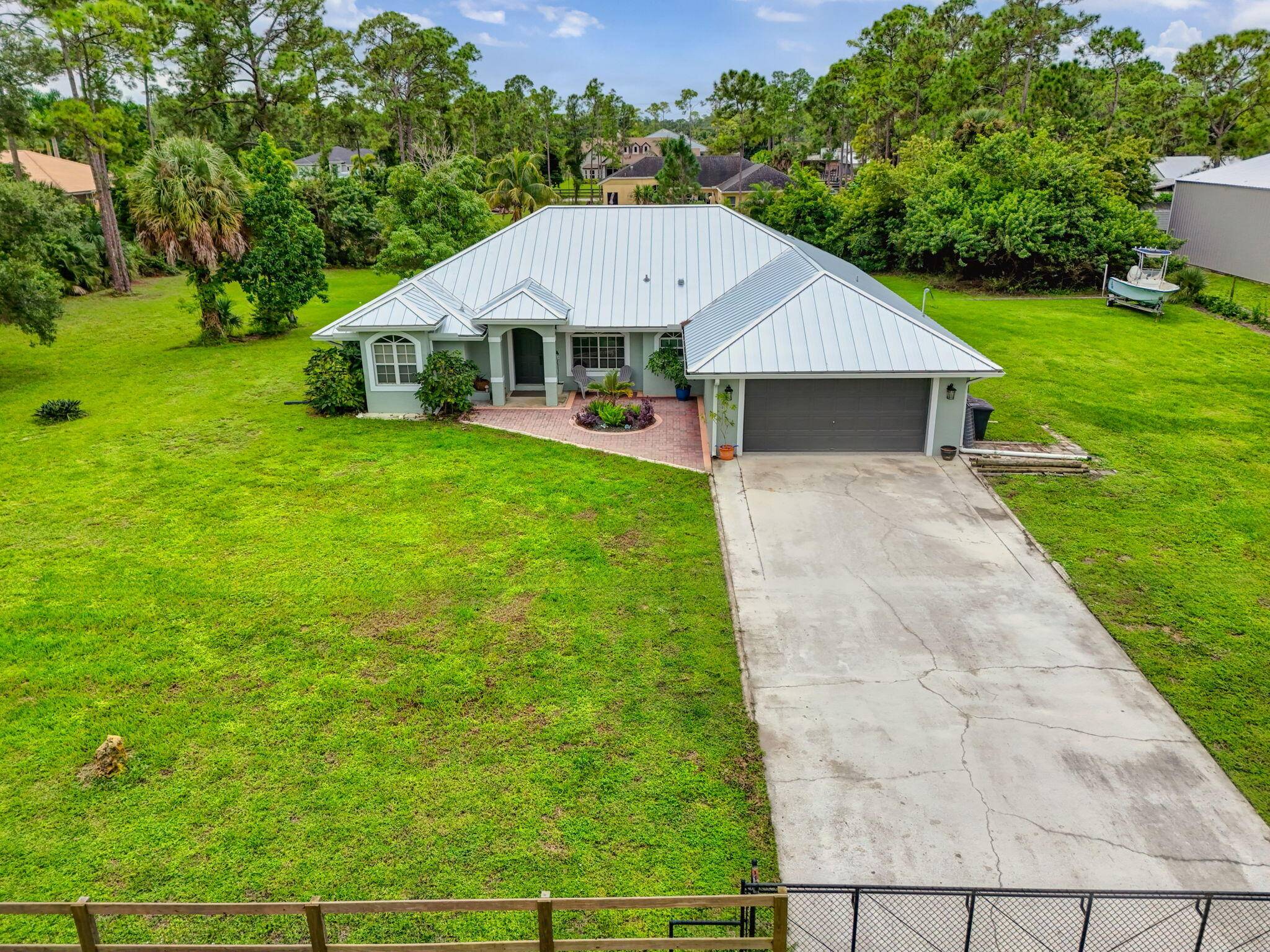 Beautiful CBS home on 1. 15 acre lot with open floorplan, new metal roof gutters 2022, new water softener and well pump 2023, new patio screening 2024, new vinyl flooring ...