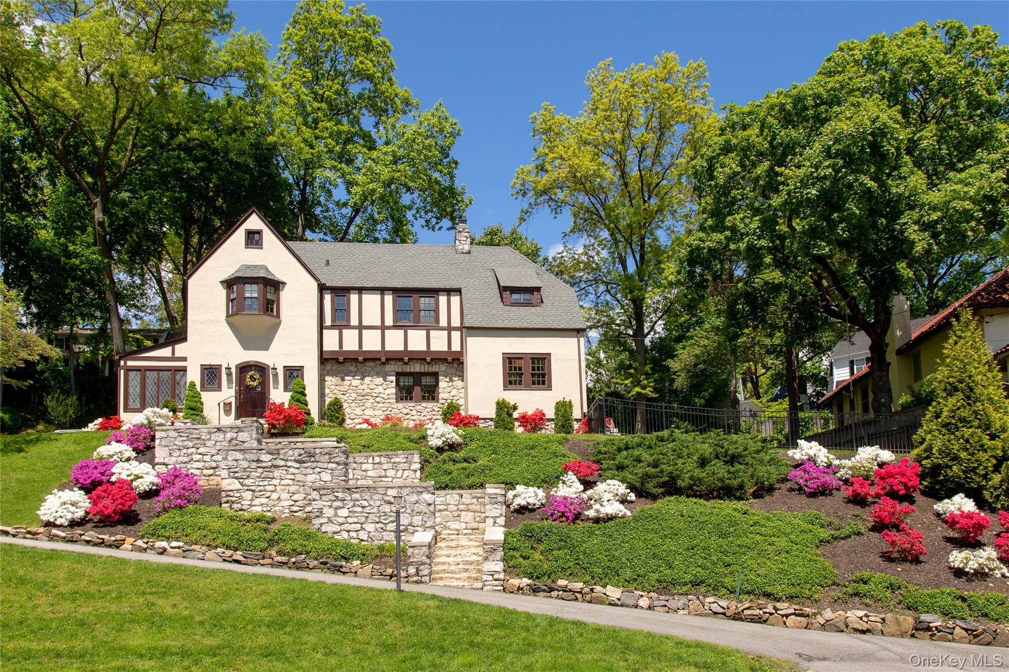 Perched gracefully above the tree lined streets of Bronxville PO's coveted Cedar Knolls neighborhood, this classic 1913 Tudor blends timeless architectural character with modern day comfort.