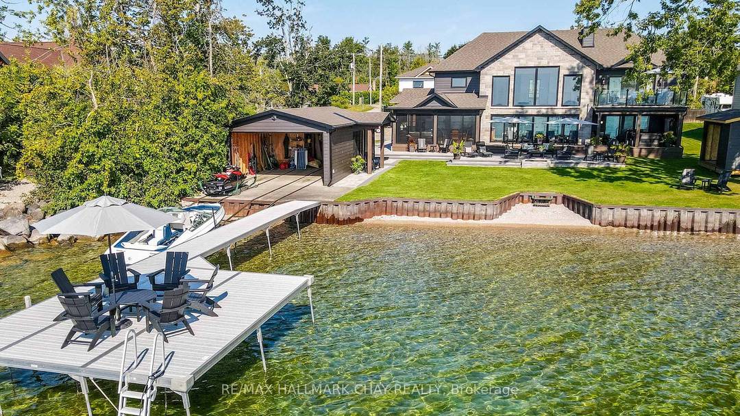 Exceptional south facing lakefront estate offering 4370 sq ft of fully renovated living on 100' x 194' of flat, steel pile protected shoreline.