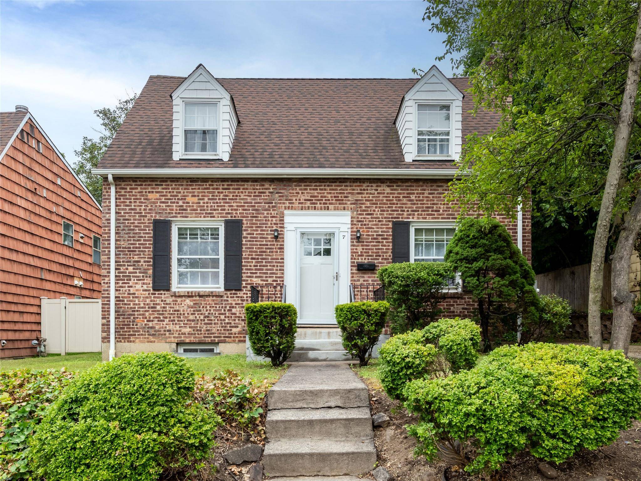 Enjoy the in town convenience of this charming brick Cape.
