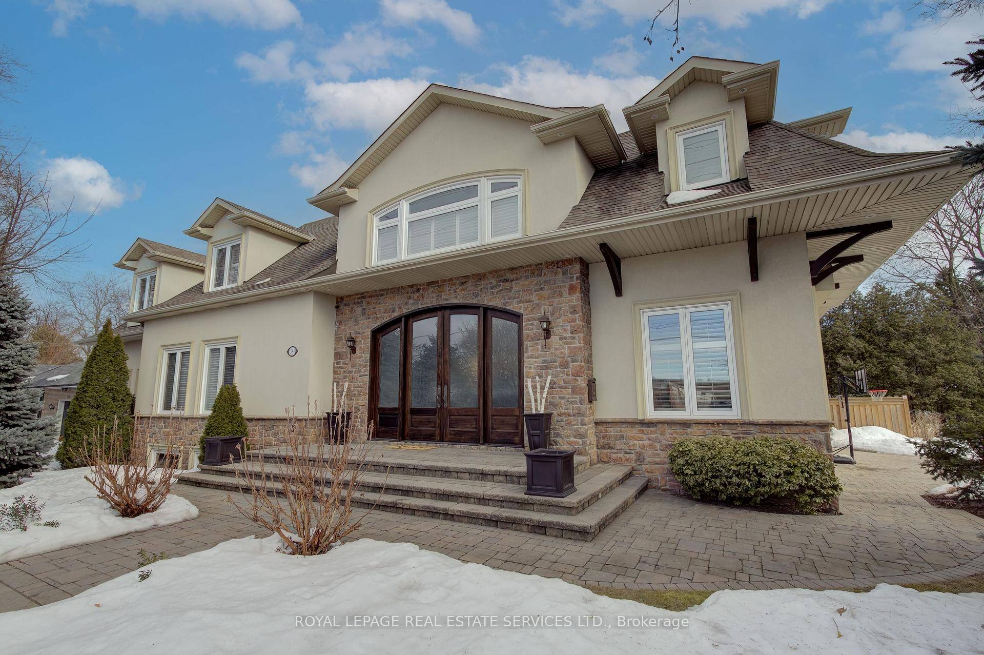 From the moment you step through the 12' mahogany doors into the stunning 2 storey foyer, this home captivates with its rare blend of warmth and grandeur.