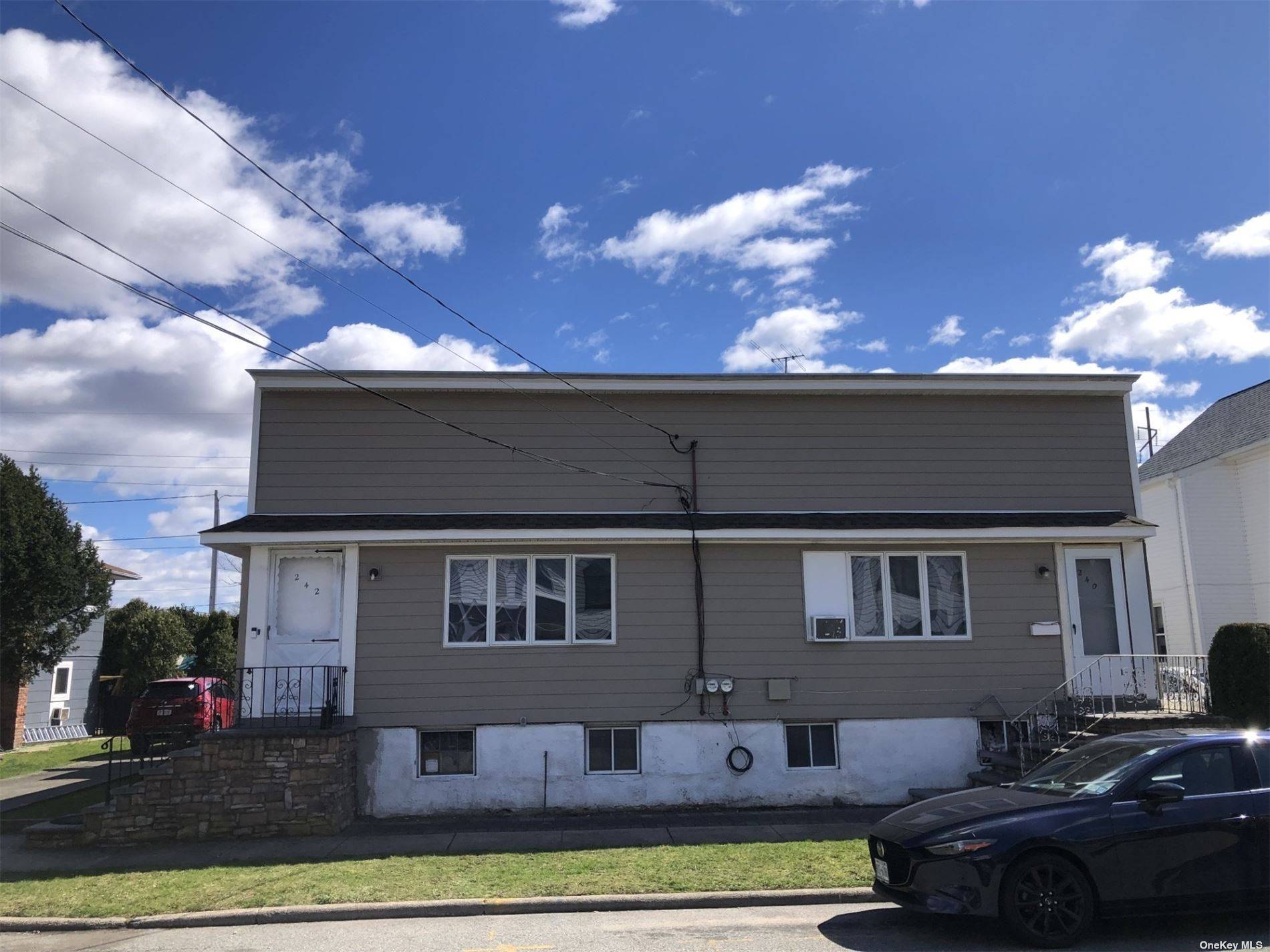 In the heart of Carle Place, this beautiful Semi attached legal 2 family house.