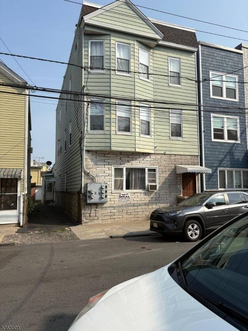 Rare 4 family house in Ironbound with common driveway leading to a 2 car garage, Second and third floor apartments totally renovated with central air.