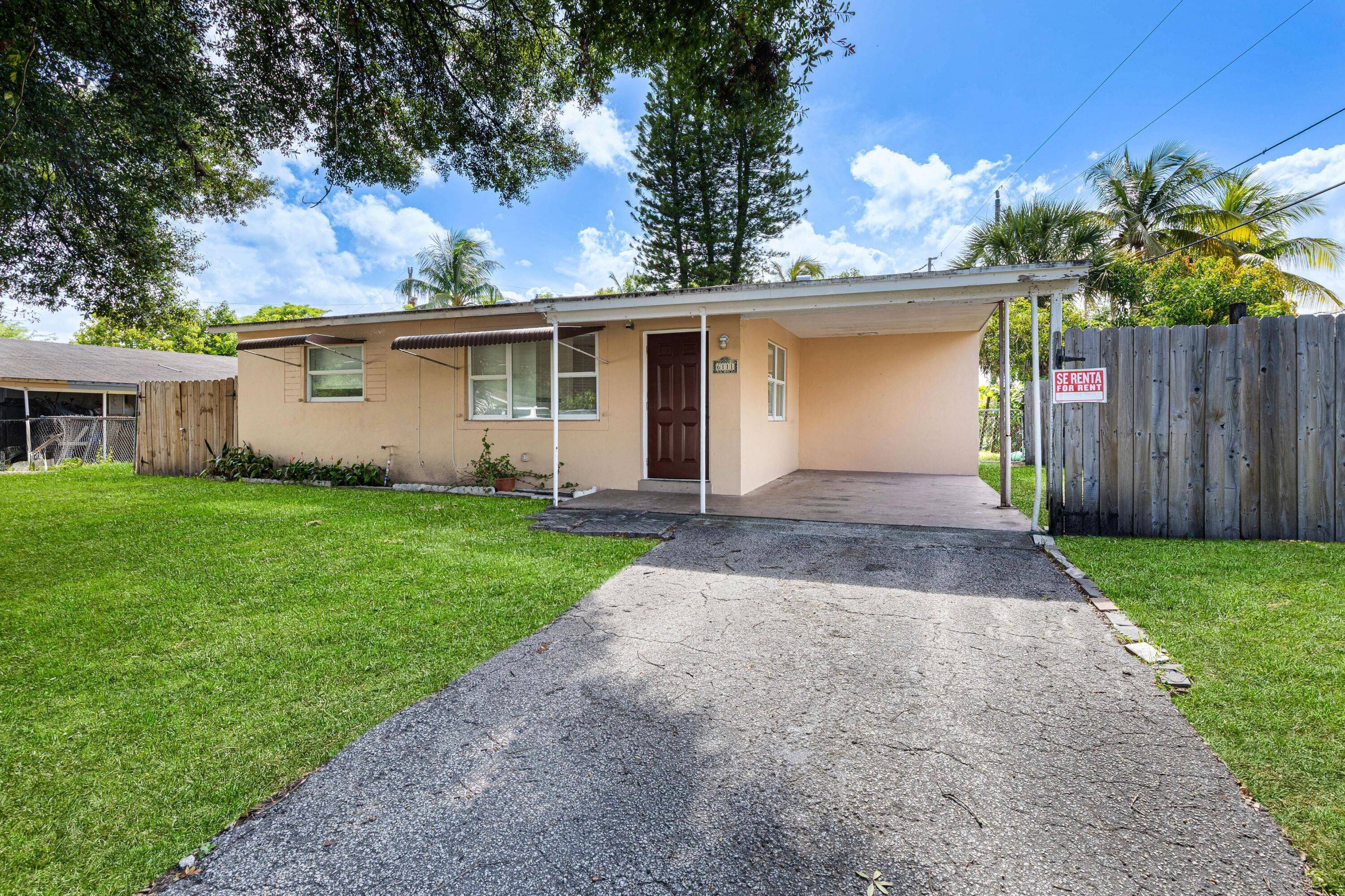 Centrally Located ! This light filled home features newer Hurricane Impact Windows, granite countertops, tile flooring, and a spacious laundry room.