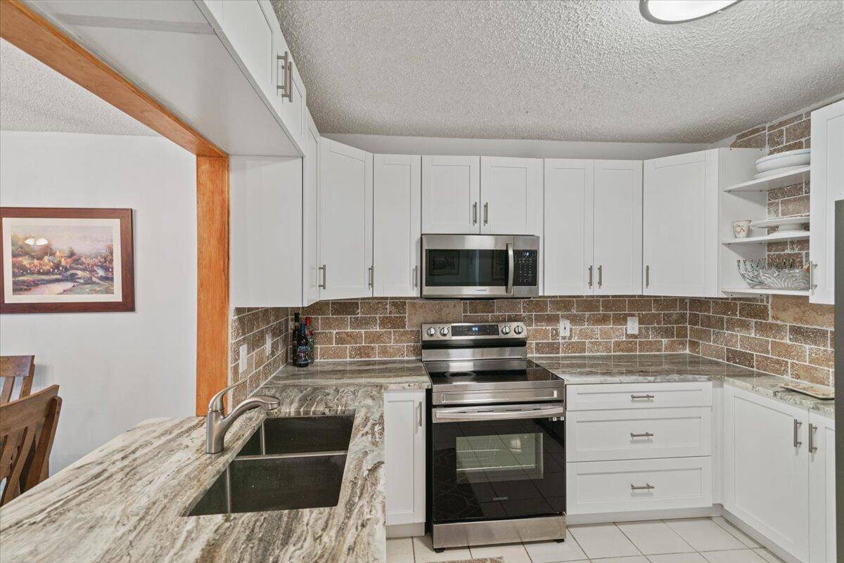 Welcome to 9244 Flynn Circle, a beautifully updated 2 bedroom, 2 bathroom home offering a perfect blend of modern luxury and serene lakefront living.