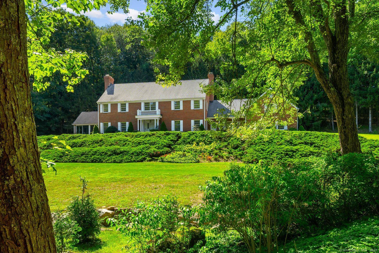 Through stone columns along a scenic approach is this first time on market custom built five bedroom brick house on four private acres.