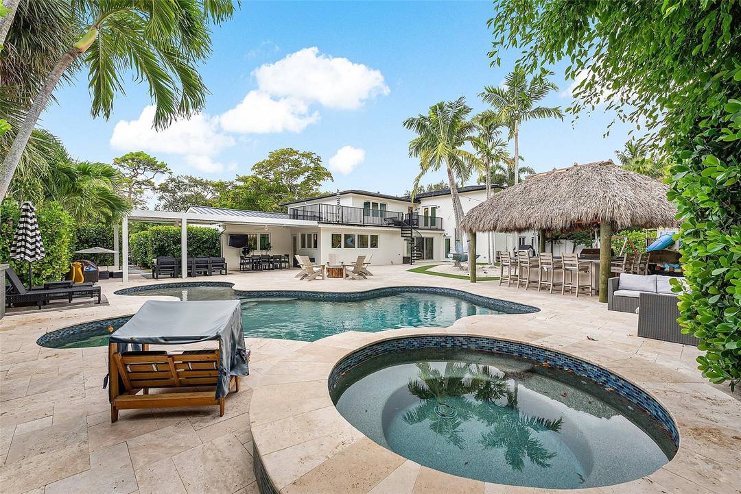 This stunning residence blends timeless farmhouse charm w sleek modern design in the heart of Fort Lauderdale s prestigious Coral Ridge community.