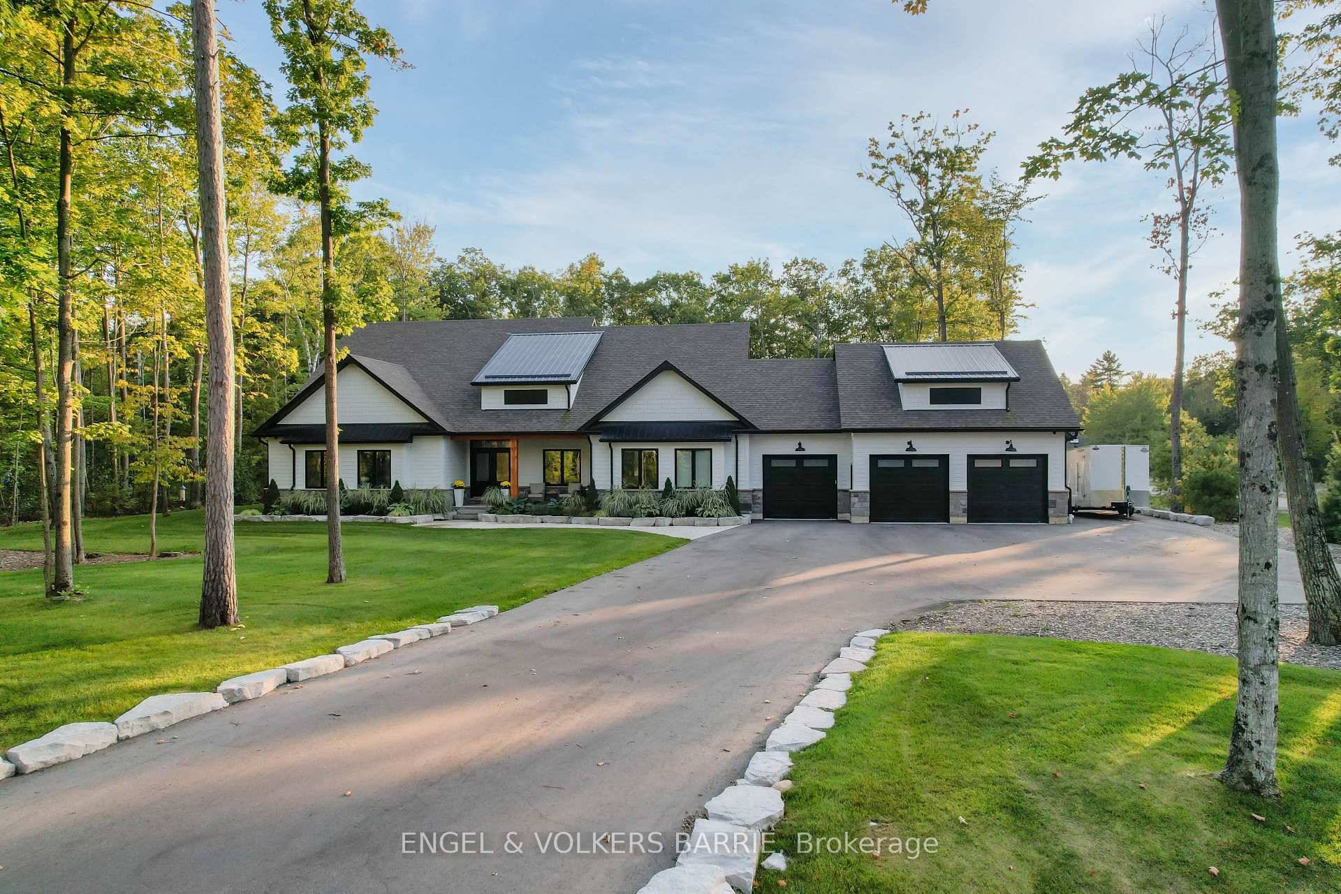Welcome to this stunning custom built home in Tiny Township, set on a private 1.