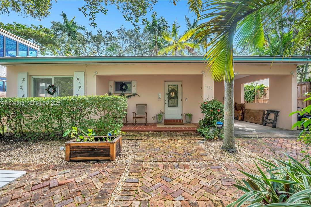 Discover this meticulously renovated Coconut Grove retreat where 1940s character meets modern sophistication.