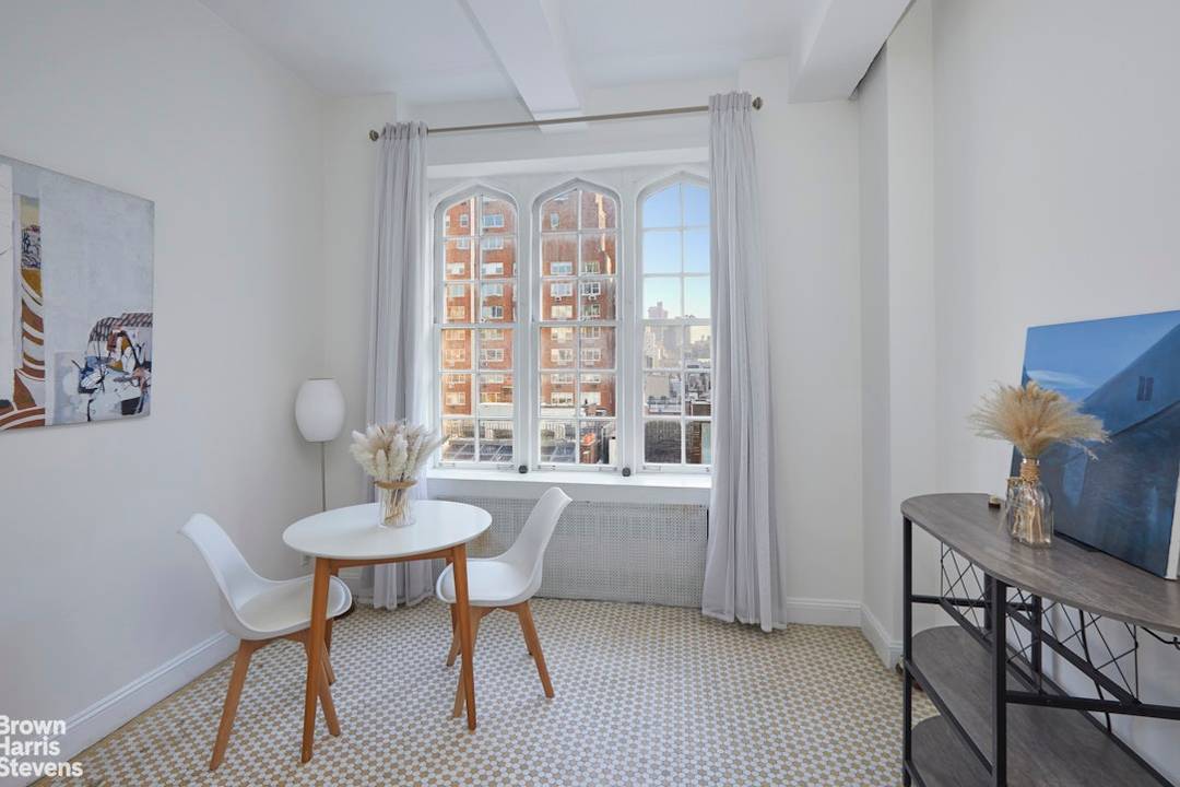As you step into this charming studio, you are immediately drawn to the graceful arched windows, filling the space with soft eastern light and a warm, welcoming feel.