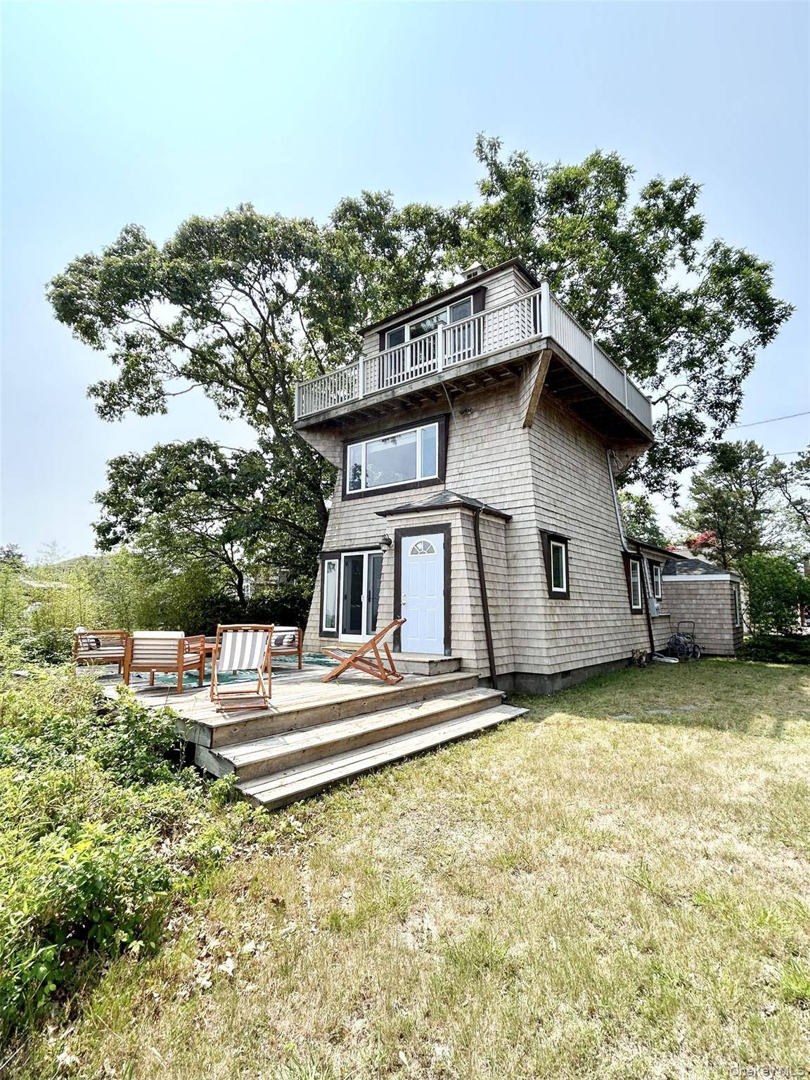 A spectacular location and a unique lighthouse style home, with 3 levels overlooking Shinnecock Bay in the premier bay front community of East Quogue.