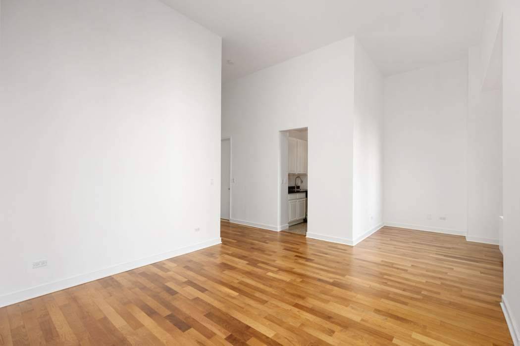 Step into this dramatic, loft like studio where soaring 13 foot ceilings and oversized windows fill the living and sleeping space with abundant natural light.