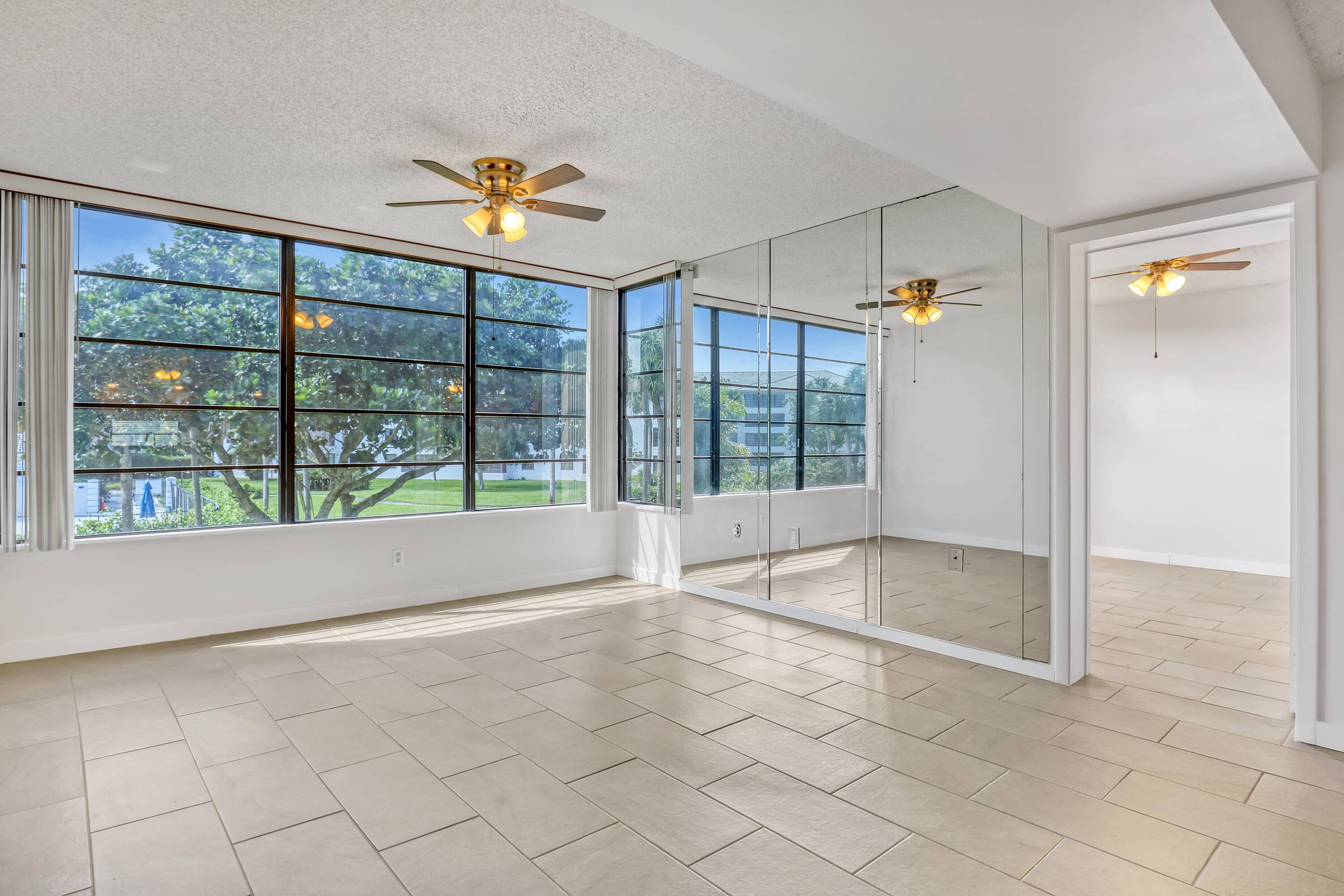 DiVosta built CORNER UNIT CONDO, 2 bedroom 2 bath, 2nd floor, SPACIOUS 1442 sq ft, TILE THRU OUT, HURRICANE IMPACT GLASS WINDOWS, bonus room perfect for home office den extra ...