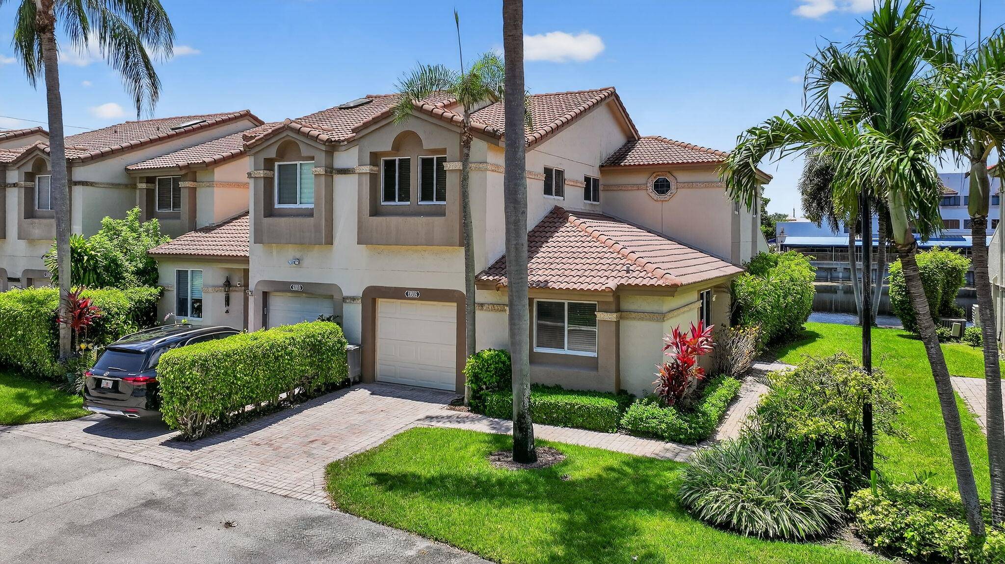WATERFRONT LUXURY ! Rarely available 3BR 3BA Corner Townhome w garage on a Premium Lakefront lot in prestigious Cortina at Boca Pointe.