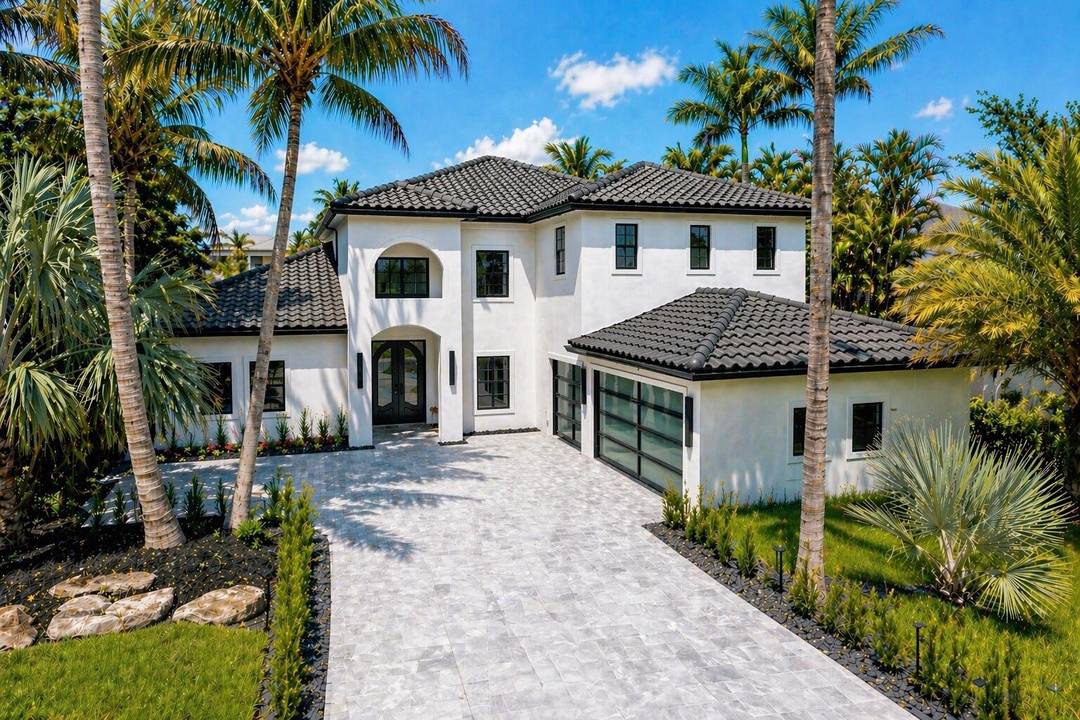 Completely renovated luxury residence in The Oaks of Boca Raton with stunning wide lake views.