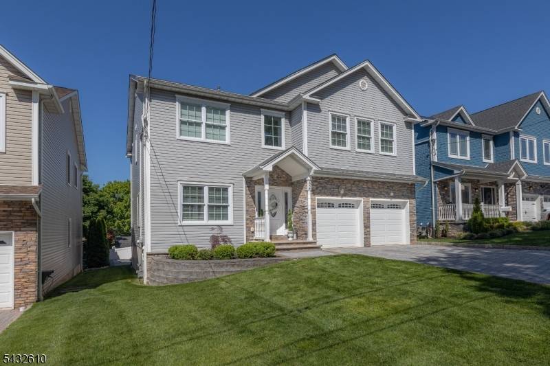 Stately two story luxury home set on a professionally landscaped property, with symmetrical architecture, blends timeless elegance with upscale modern comfort, offering expansive living spaces, refined finishes, and thoughtful accommodations.