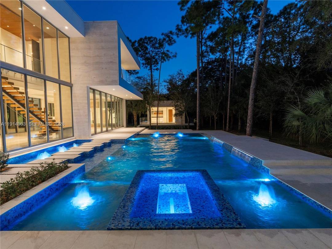 Villa Acqua di Gioia in the heart of North Pinecrest, blends modern sophistication with serene privacy on a prime corner lot.