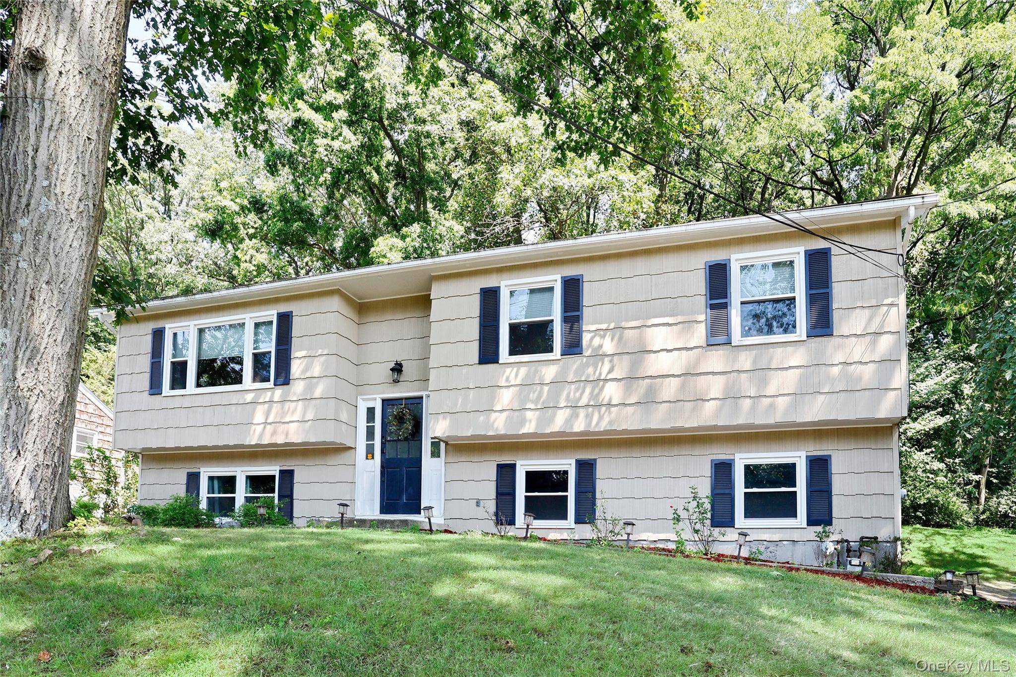 Move right into this beautifully maintained 4 bedroom hi ranch, set on a lovely property surrounded by mature trees.