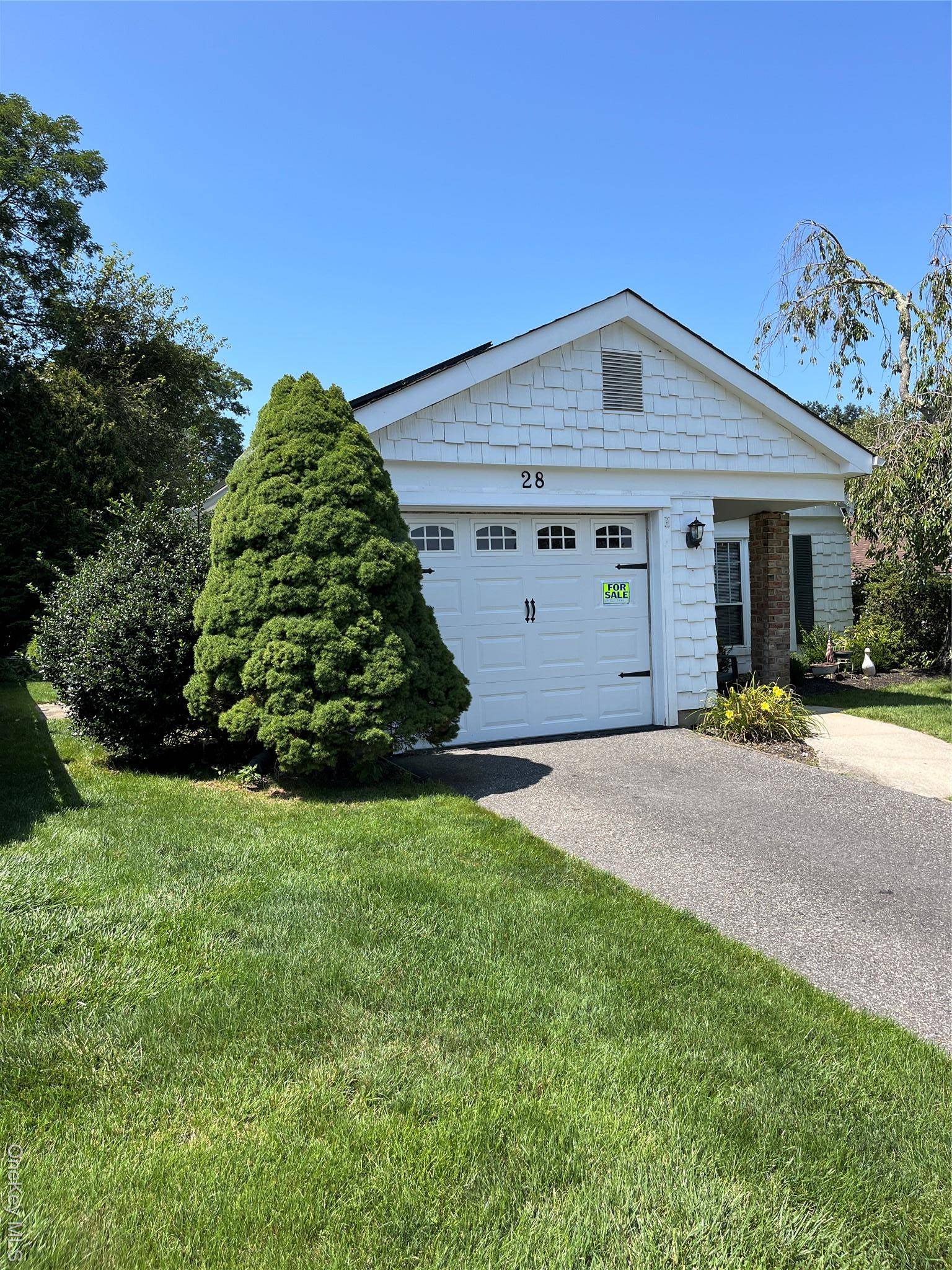 Beautiful Heather model. Spacious entry with wood floors, invites you into the home and gives an open view past the two season room to the private backyard.
