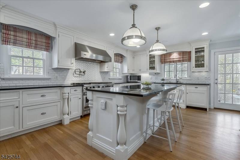 Nestled in the prestigious Spring Brook neighborhood, this timeless 1930s Colonial blends historic charm with modern luxury.