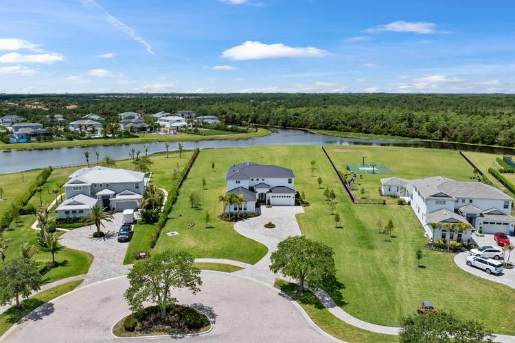 Experience a RARE level of LUXURY in this completely reimagined estate, ideally positioned on one of the LARGEST and most PRIVATE lots within the prestigious Bridgewater community of Jupiter.