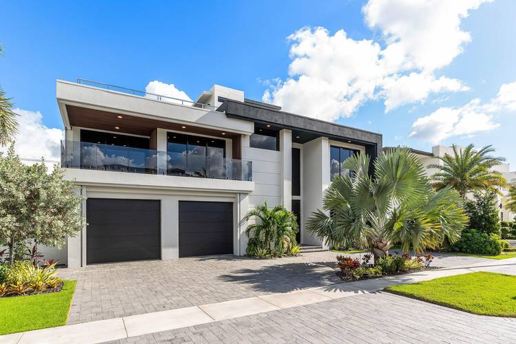 Built in 2023 by Primo Luxury Homes, this striking three story modern estate in Boca Villas offers 6 bedrooms, office, 6.