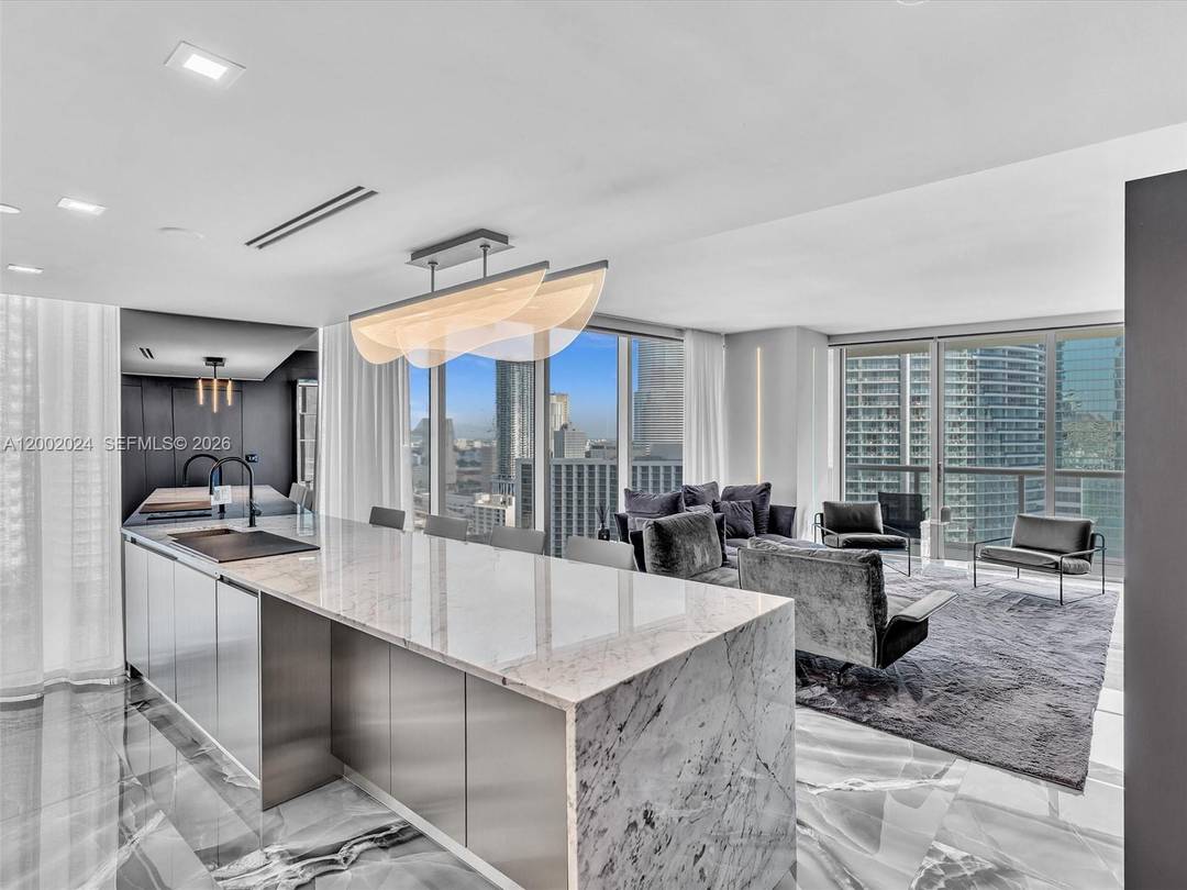 Completely reimagined designer residence at Icon Brickell offering 1, 168 SF of sophisticated living with expansive floor to ceiling glass and stunning Miami River and skyline views.
