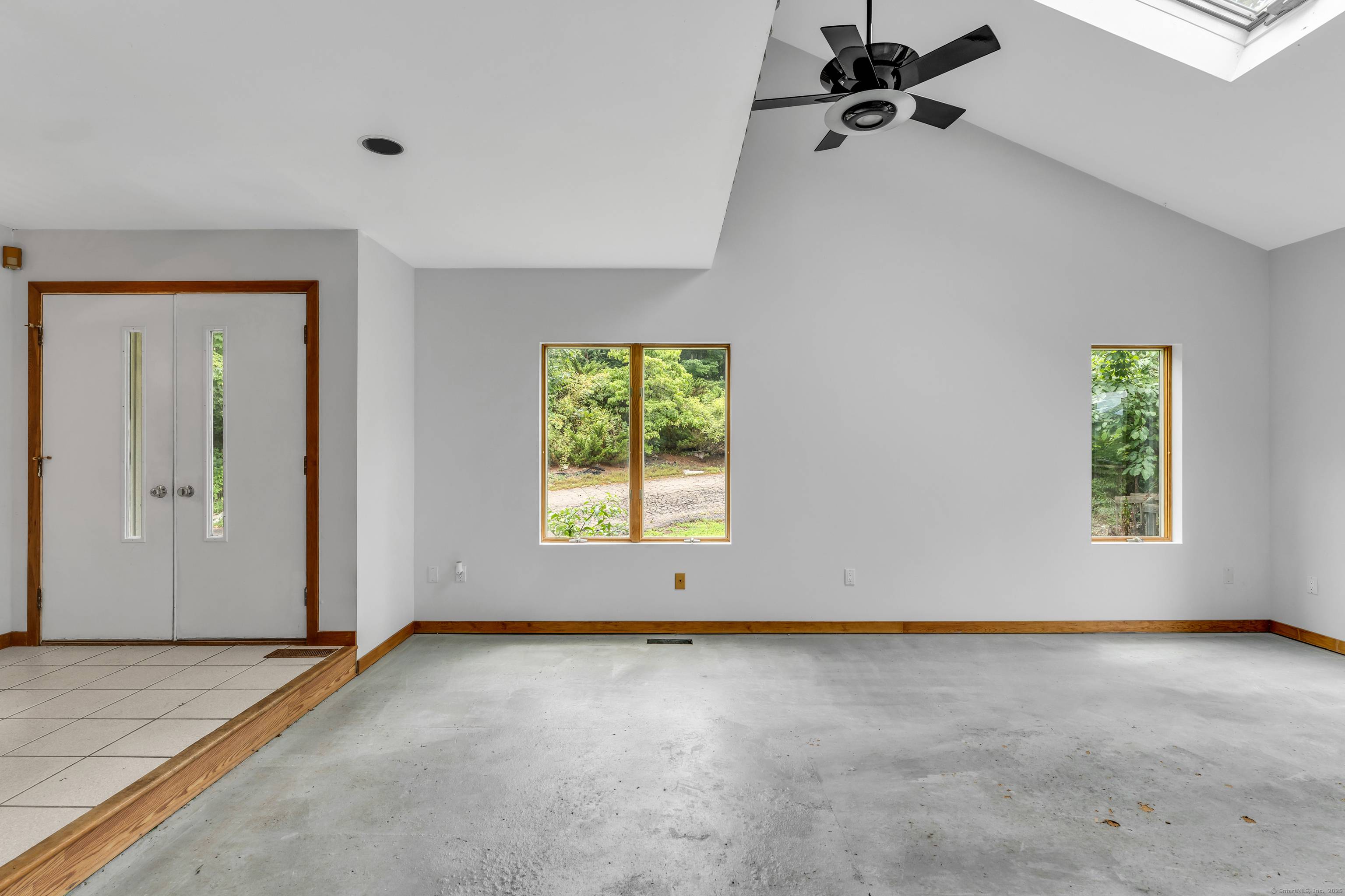 Perched atop a scenic hill on four acres, this stunning custom built home offers a blend of privacy, nature, and design.