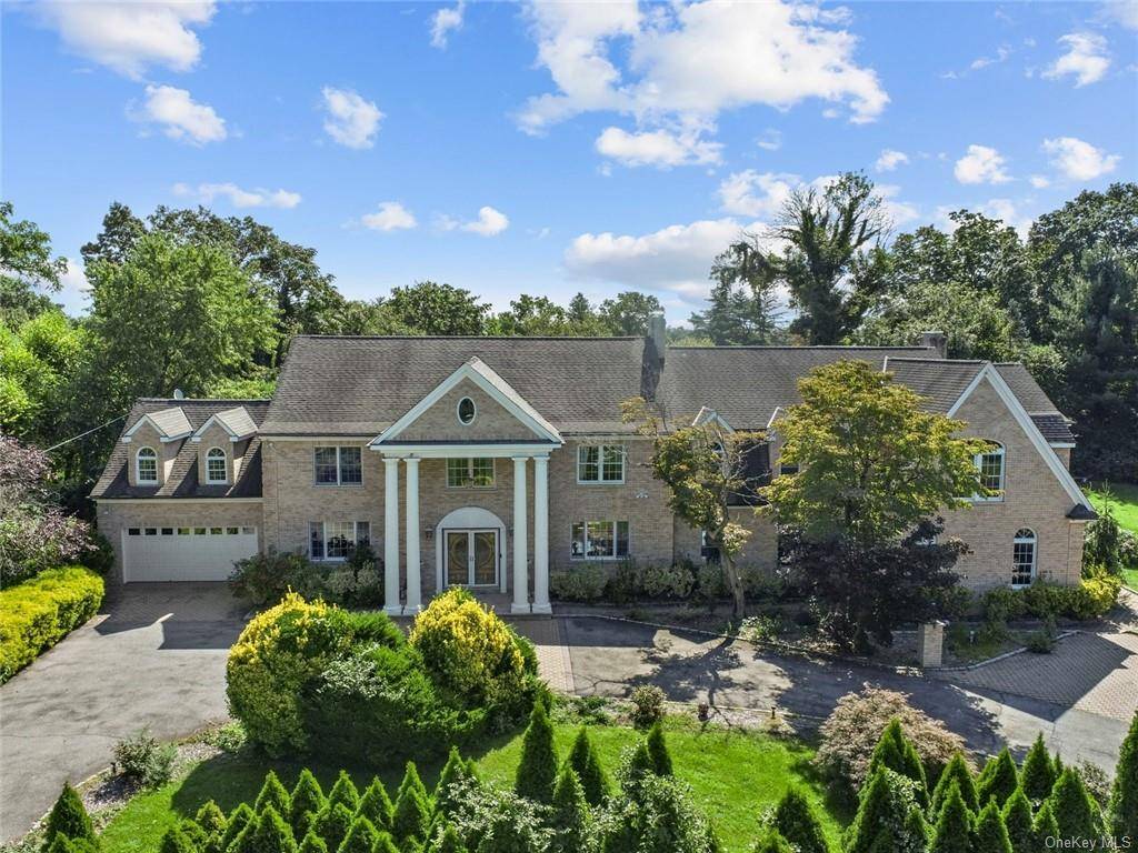 EXQUISITE COLONIAL FOR SALE IN A SECURE GATED ESTATE WITH OPTION FOR SELLER'S PRIVATE FINANCING Nestled on an expansive 1.