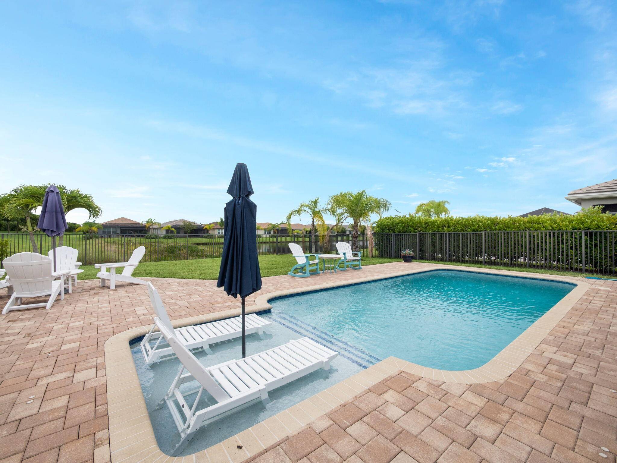 Live the dream in this stunning lakefront pool home, perfectly situated on an oversized corner lot in the highly sought after Valencia Cay at Riverland !