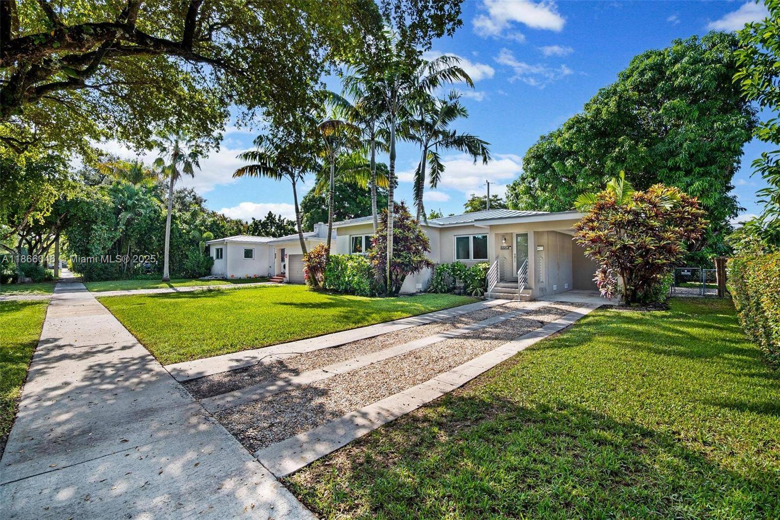 Charming 2 bedroom, 1 bath home in Virginia Gardens featuring a new metal roof, impact aluminum casement windows, and beautifully refurbished oak hardwood floors.