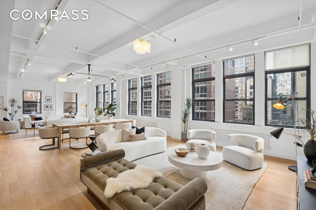 Spectacular sprawling full floor LOFT with 12 foot ceilings and 30 oversized windows facing north, south, east and west, showering the apartment with light all day.