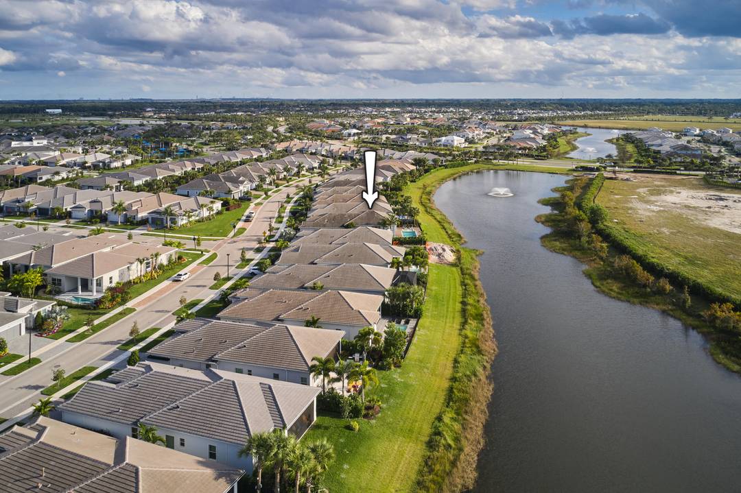 Spectacular lake view home in Avenir's top 55 active adult community called Regency.