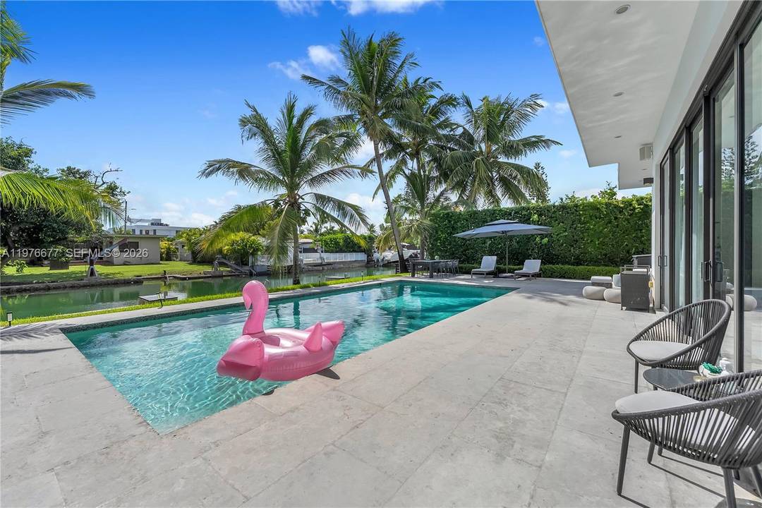 Located on the exclusive gated island of Biscayne Point, this modern waterfront residence blends timeless design with turnkey convenience.
