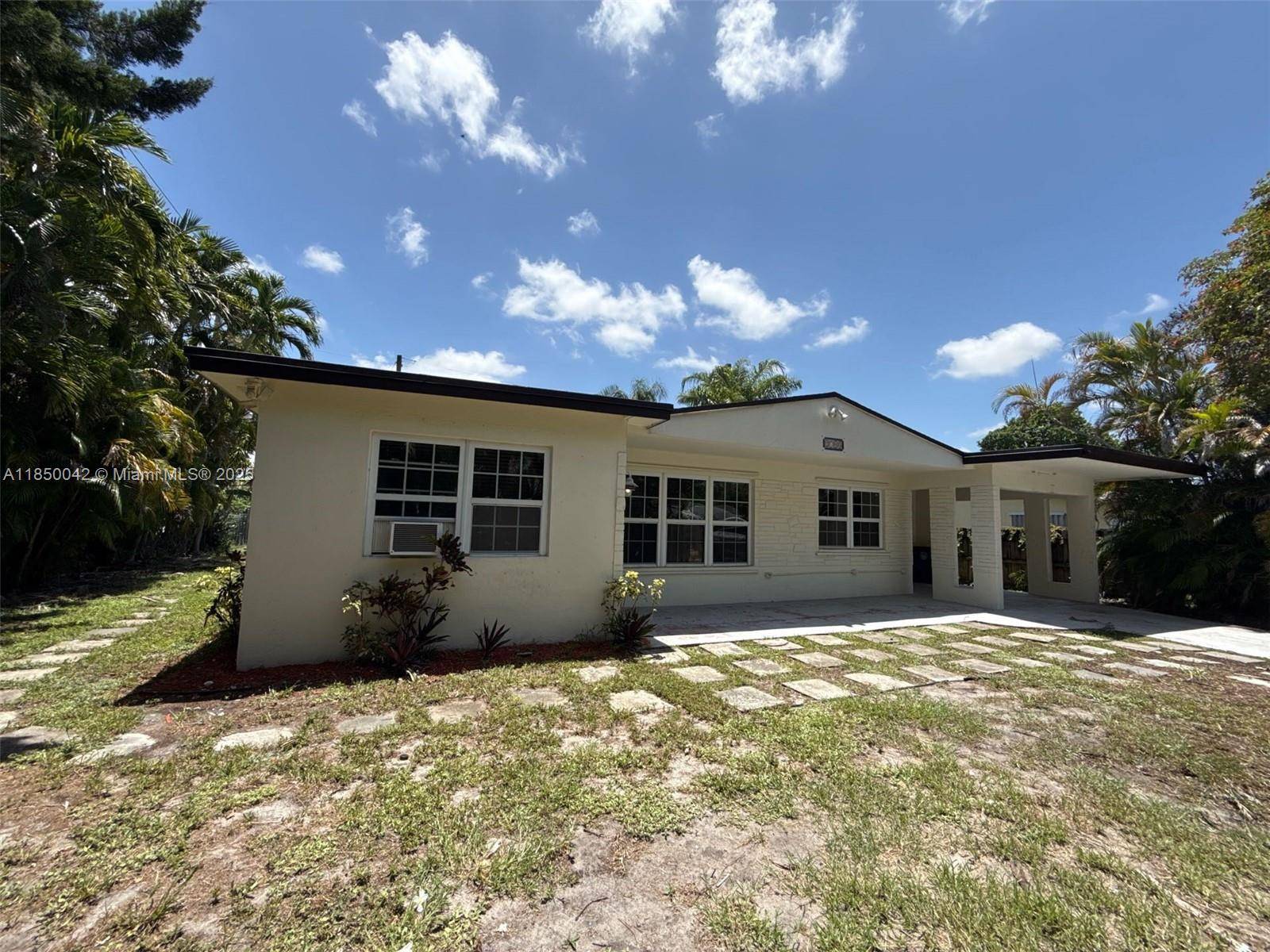 Ranch style home in good condition featuring a 3 2 layout, a carport, and a well kept backyard.