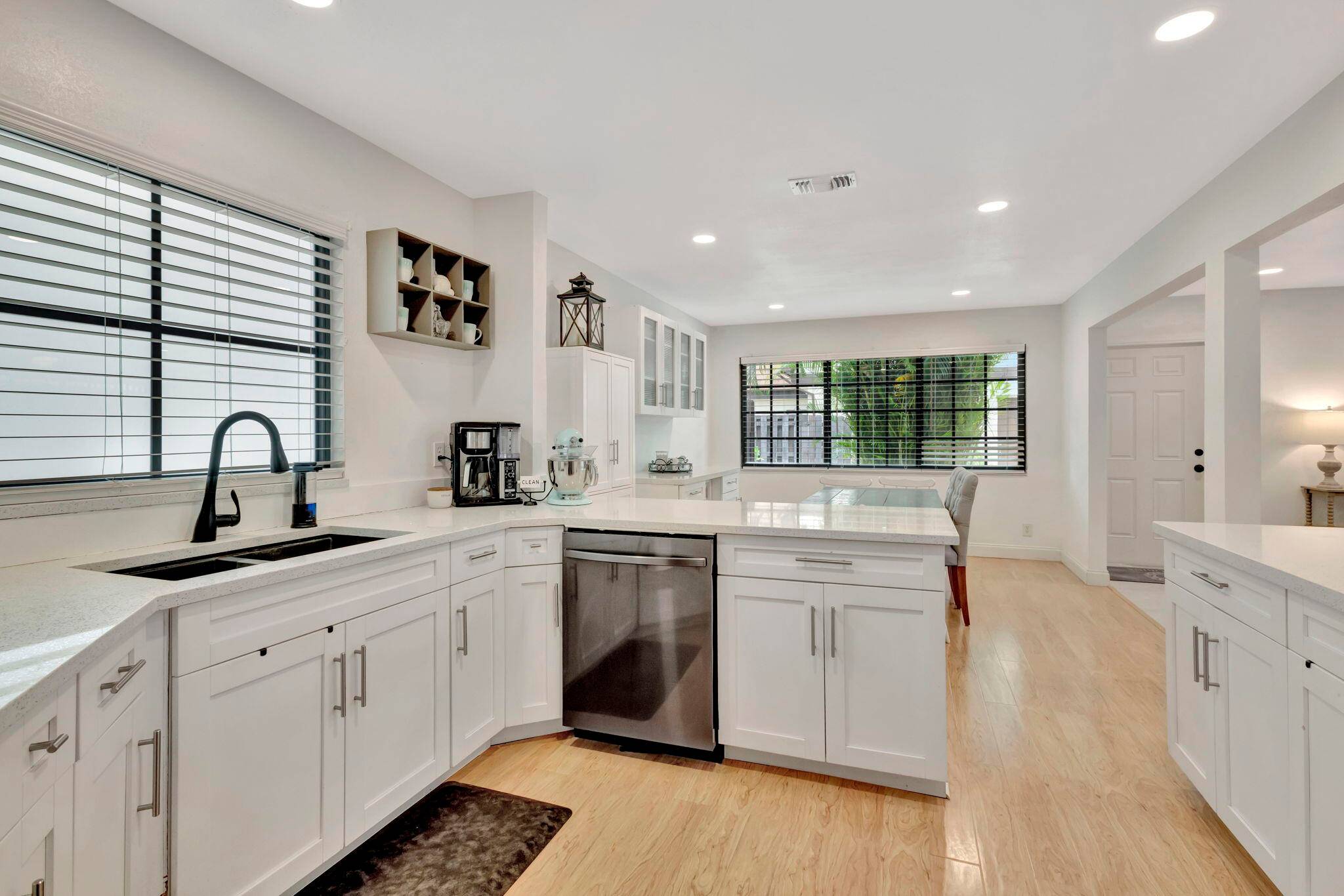 This spacious townhome comes with recently installed impact windows, a renovated kitchen with shaker style cabinets, quartz countertops, and stainless steel appliances.