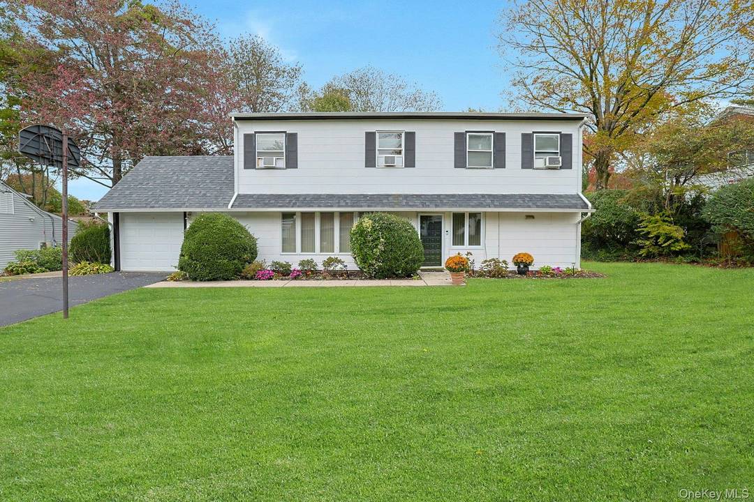 Sunny and spacious Colonial set on a tranquil street with a wonderful, level backyard designed for comfortable everyday living and easy entertaining.