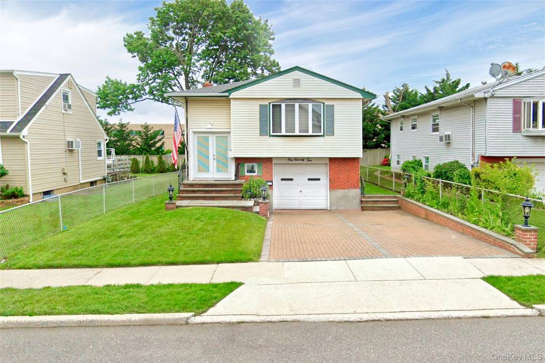 Updated hi ranch ideally located in the heart of Garden City Park and within the Mineola School District.