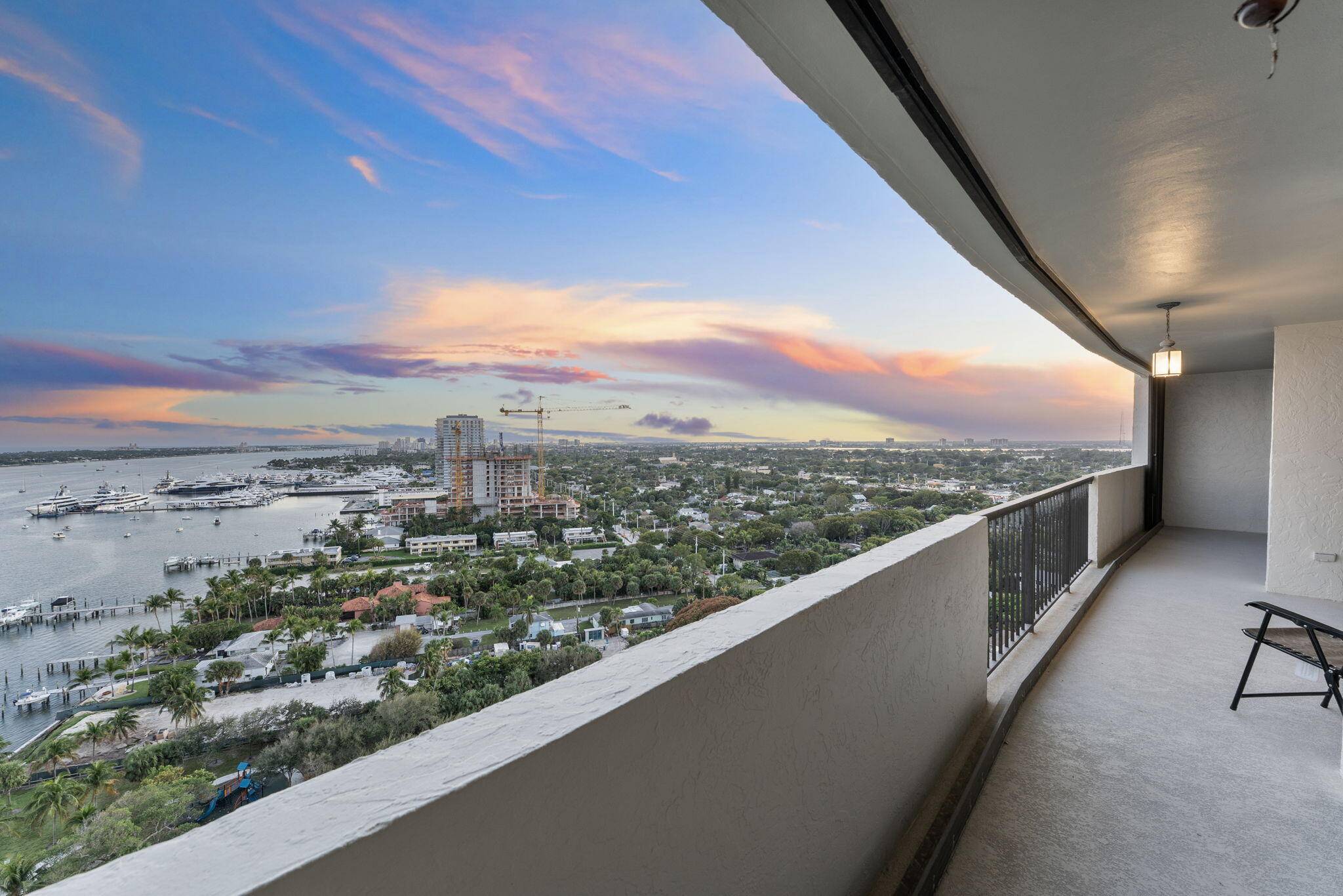 Perched high above the sparkling waters, this stunning 2 bedroom, 2 bathroom residence offers breathtaking panoramic views of the Ocean, Intracoastal Waterway, Palm Beach Island, and the Rybovich Superyacht Marina.