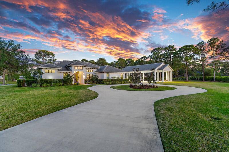 Discover unparalleled luxury in this exquisite 3 bedroom, 3 bathroom modern home, complete with an office den, nestled within the prestigious gated equestrian community of Stuart West.