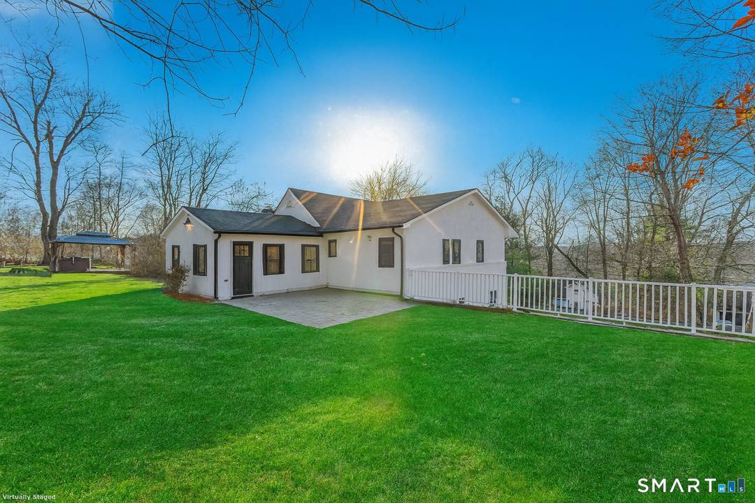 Welcome to 8 Fulton Drive, New Fairfield, CT a beautifully renovated home set on a rare double lot, nestled between Putnam Lake and Ball Pond.