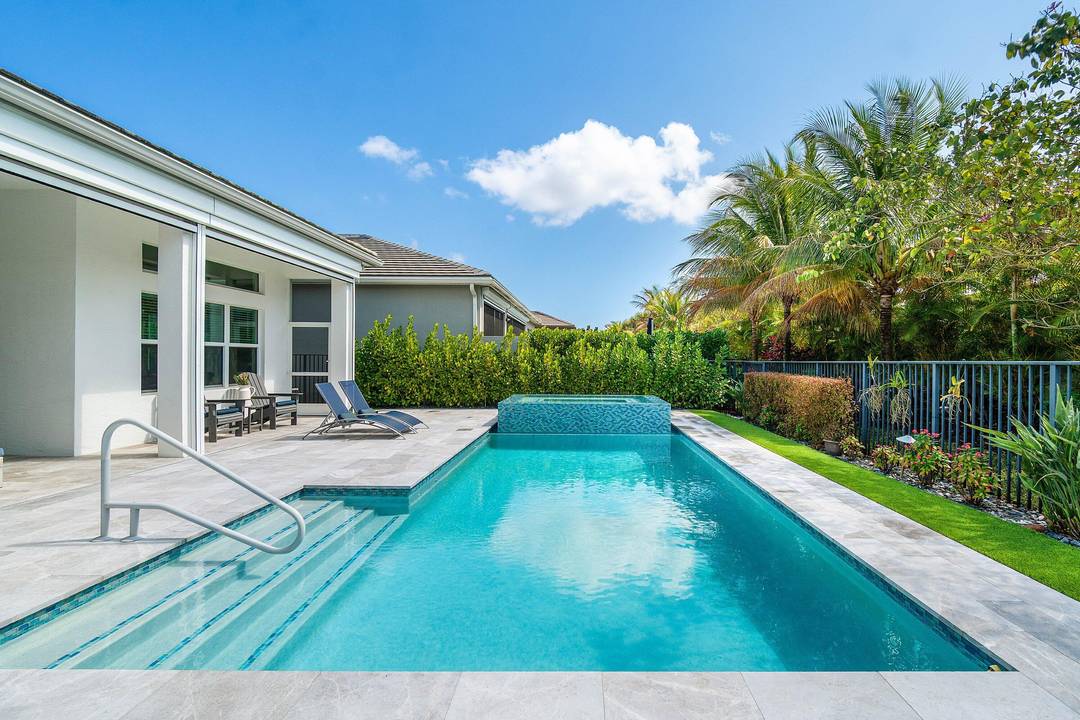 Enjoy the best of indoor outdoor living in this beautifully upgraded home featuring a private heated pool and spa with an expanded travertine paver deck and motorized retractable hurricane and ...