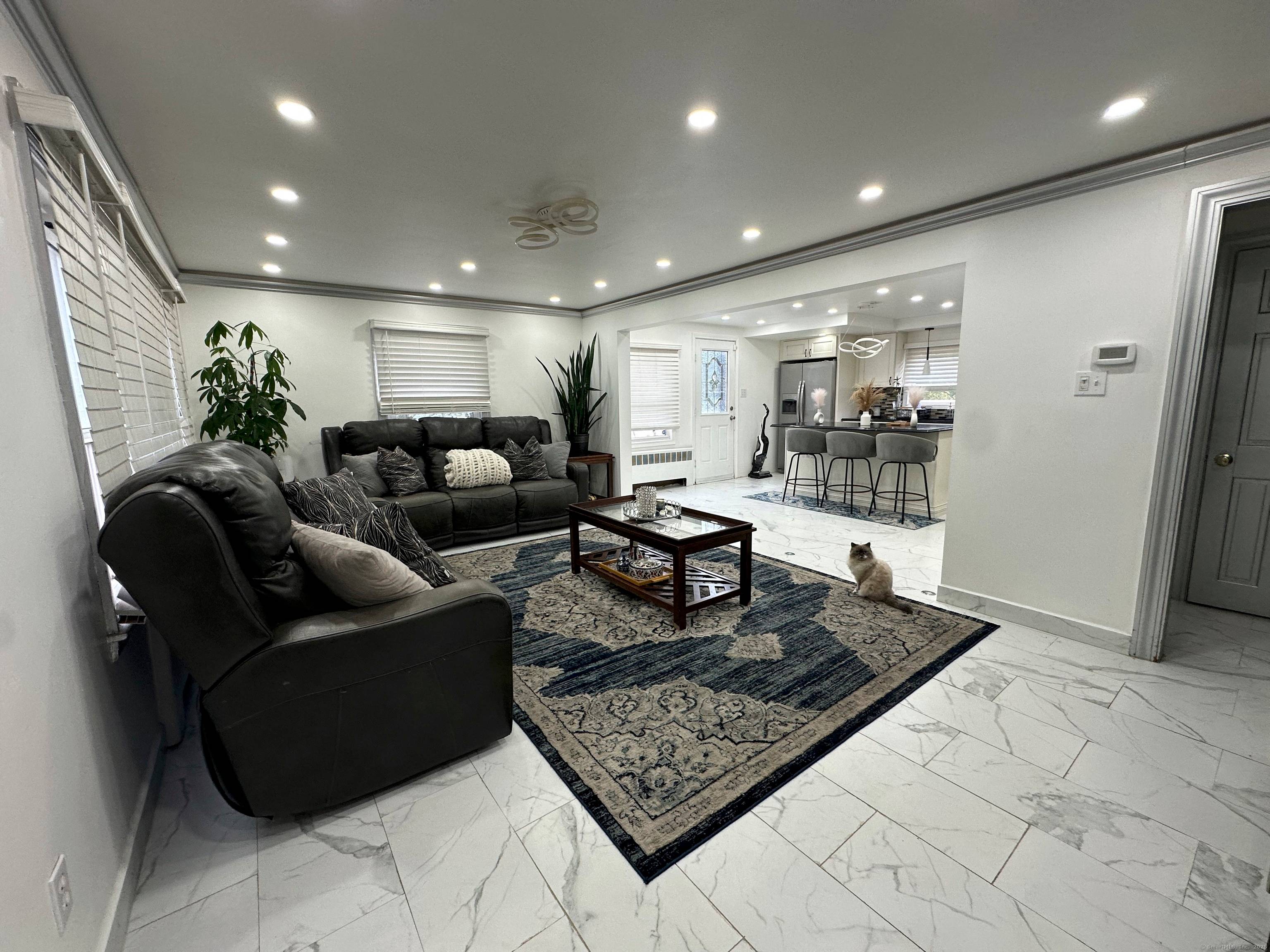 Welcome to 39 Draper Ave, Meriden, CT 06450 a beautifully renovated 1950 brick home that perfectly balances timeless craftsmanship with modern comfort.
