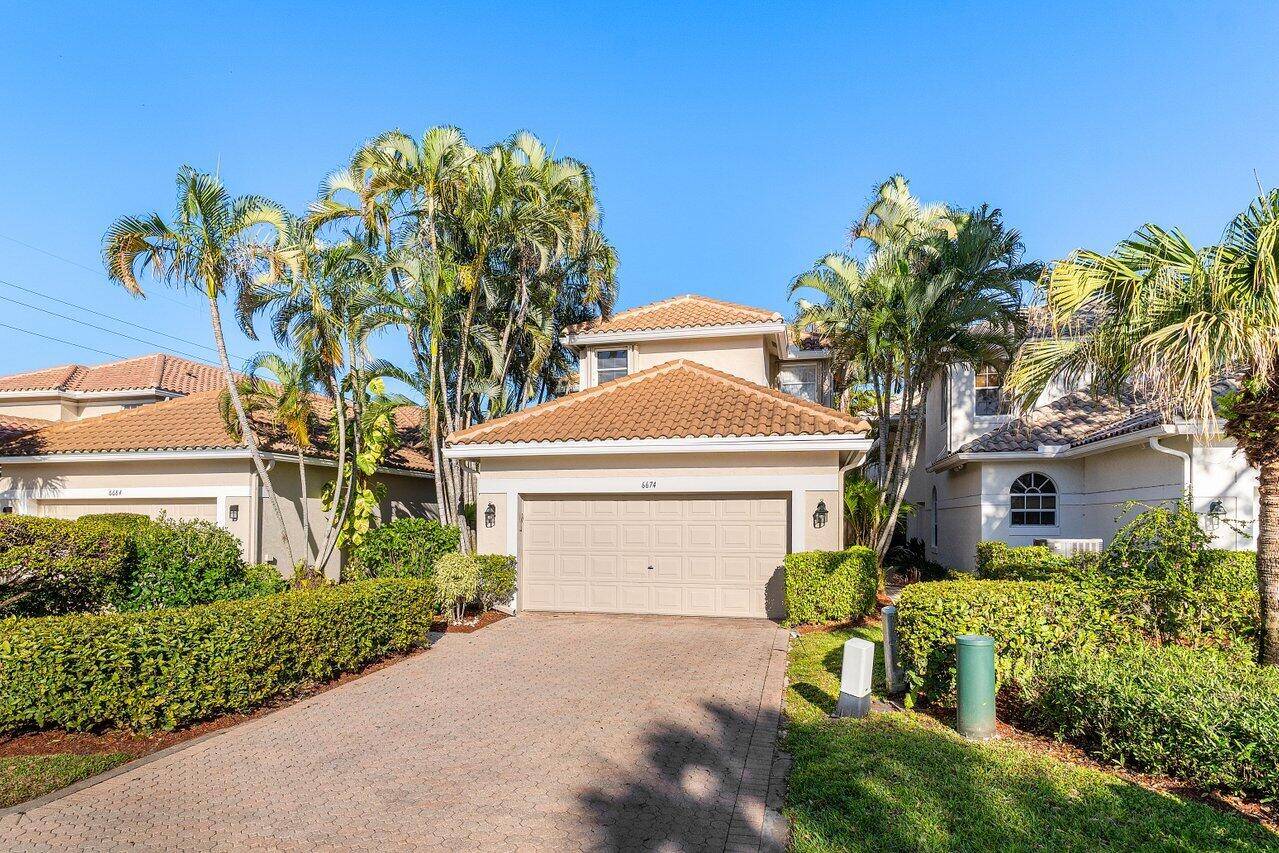 Nestled within the serene confines of Broken Sound Country Club's Banyans community, this elegant 3BD 2.